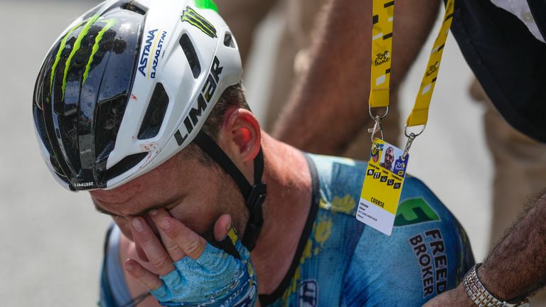 Britain's Mark Cavendish receives medical assistance after crashing during the eighth stage of the Tour de France cycling race over 201 kilometers (125 miles) with start in Libourne and finish in Limoges, France, Saturday, July 8, 2023. (AP Photo/Thibault Camus)