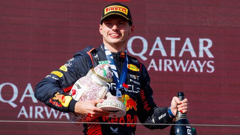 HUNGARORING, HUNGARY - JULY 23: Max Verstappen, Red Bull Racing, 1st position, holds his broken trophy during the Hungarian GP at Hungaroring on Sunday July 23, 2023 in Budapest, Hungary. (Photo by Glenn Dunbar / LAT Images)