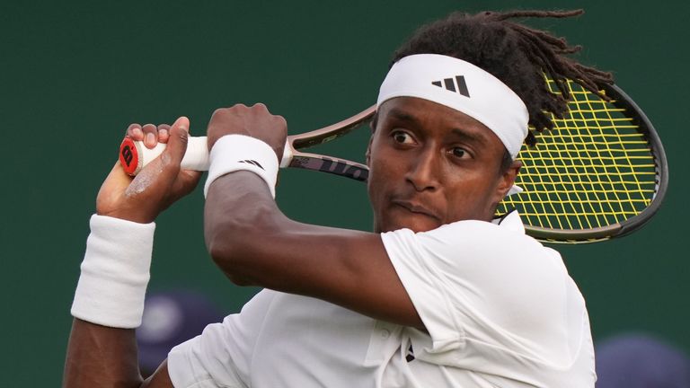 Sweden's Mikael Ymer returns to Slovakia's Alex Molcan during their match at Wimbledon
