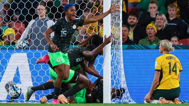 Nigeria players celebrate after teammate Osinachi Ohale, bottom inside the goal, scored their side's second goal during the Women's World Cup Group B soccer match between Australia and Nigeria In Brisbane, Australia, Thursday, July 27, 2023. (AP Photo/Tertius Pickard)
