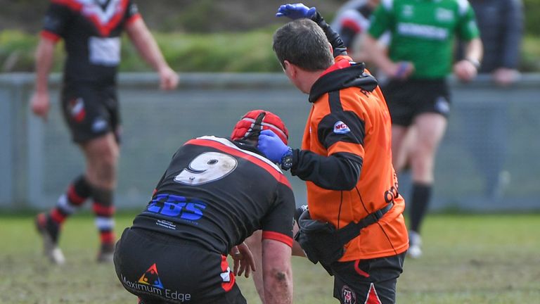 Picture by Olly Hassell/SWpix.com - 12/03/2023 - Rugby League - Betfred Challenge Cup Round 3 - Thatto Heath Crusaders v North Wales Crusaders - Hatton Solicitors Crusader Park, Thatto Heath, England - Sean Kenny of Thatto Heath Crusaders reciving treatment for a head injury