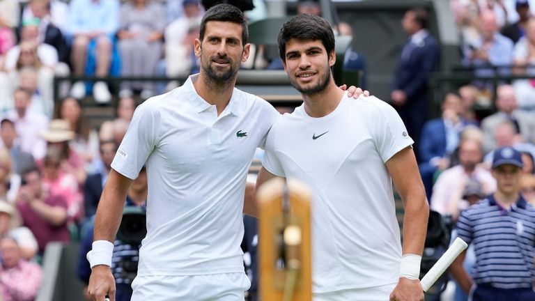 Serbia's Novak Djokovic, left, and Spain's Carlos Alcaraz pose for a photo ahead of the final of the men's singles on day fourteen of the Wimbledon tennis championships in London, Sunday, July 16, 2023. (AP Photo/Kirsty Wigglesworth)