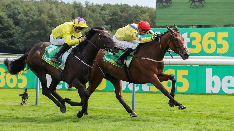 Poptronic (red cap) beats Sea Silk Road in the Lancashire Oaks