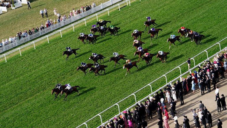 Doyle and Rhythm N Hooves (white and purple) win the Palace Of Holyrood House Stakes at Royal Ascot