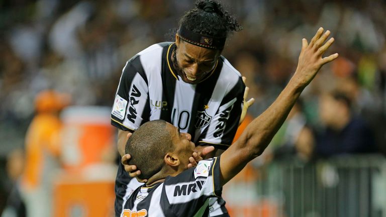 Leonardo Silva , bottom, of Brazil's Atletico Mineiro celebrates next to teammate Ronaldinho Gaucho after scoring a goal during the Copa Libertadores final soccer match against Paraguay's Olimpia in Belo Horizonte, Brazil, Wednesday, July 24, 2013.