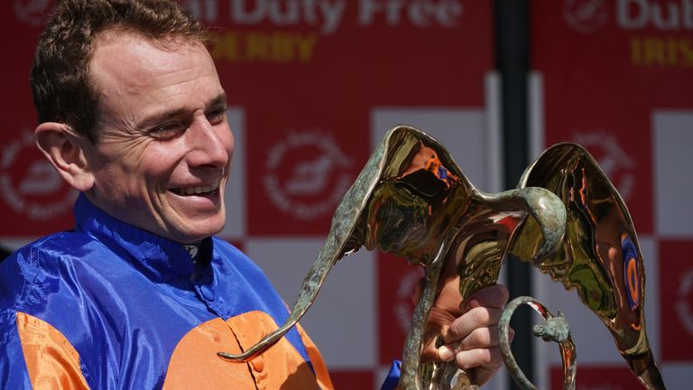 Ryan Moore lifts the Irish Derby trophy