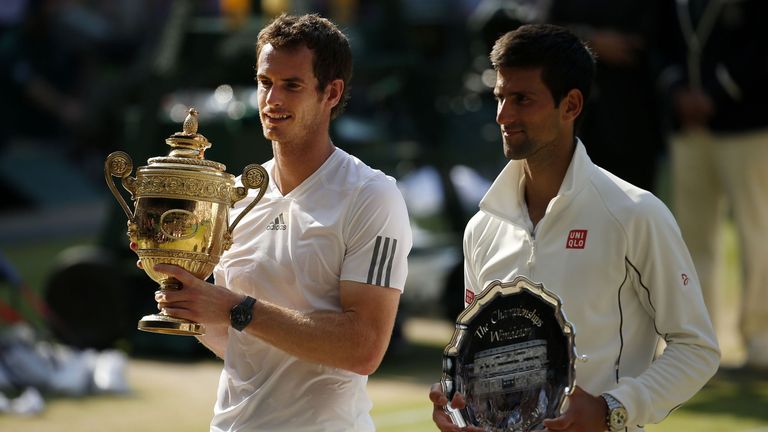 Andy Murray (L) displays the Wimbledon men's singles trophy after defeating Novak Djokovic in 2013 (PA Images)