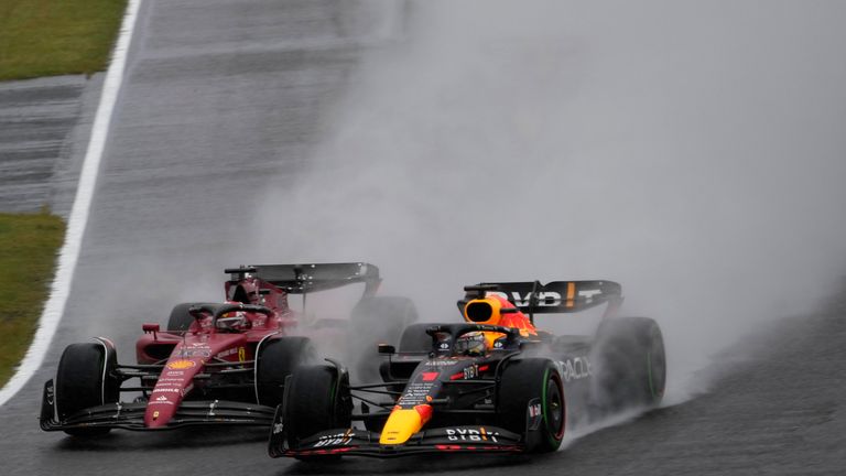 Red Bull driver Max Verstappen, right, of the Netherlands and Ferrari driver Charles Leclerc of Monaco compete in the rain during the Japanese Formula One Grand Prix at the Suzuka Circuit in Suzuka, central Japan, Sunday, Oct. 9, 2022. (AP Photo/Eugene Hoshiko)