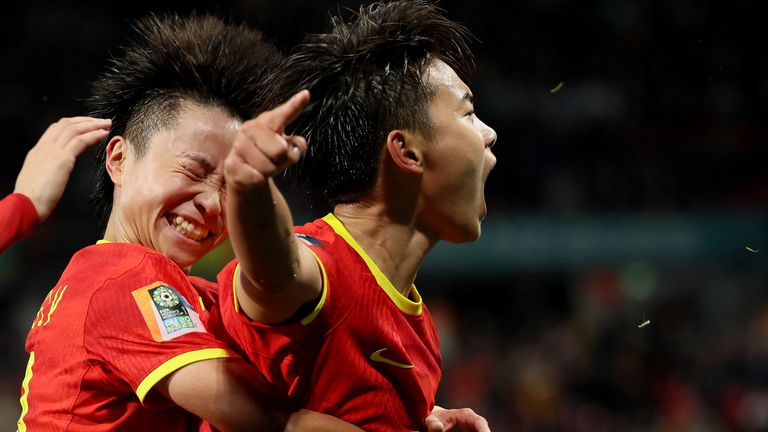China's Wang Shuang, right, celebrates after scoring the winner against Haiti