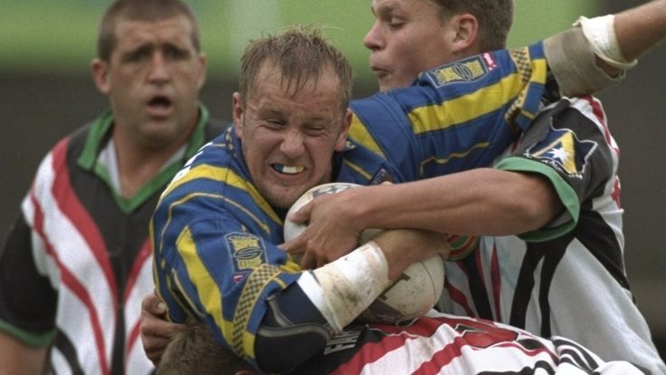 16 Jun 1997: Gary Chambers of Warrington Wolves (centre) is knocked back by the Penrith defence during the World Club Championship match at Wilderspool Stadium in Warrington, England. Penrith won the match 22-52. \ Mandatory Credit: Graham Chadwick /Allsport