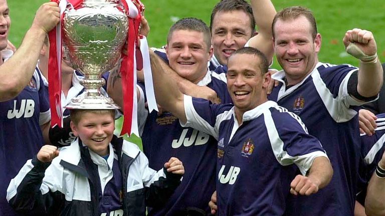 Picture by Ben Duffy/SWpix.com - 27/04/2002 - Rugby League - Kellogg's Nutri-Grain Challenge Cup Final - Wigan Warriors v St Helens - Murrayfield Stadium, Edinburgh, Scotland - Wigan's team celebrate their challenge cup victory with Ricky Bibby, , Andy Farrell (balancing the cup on his sons head), Teryy Newton, David Furner, Adrian Lam, Terry O'Connor, David Hodgson, Brian Carney.