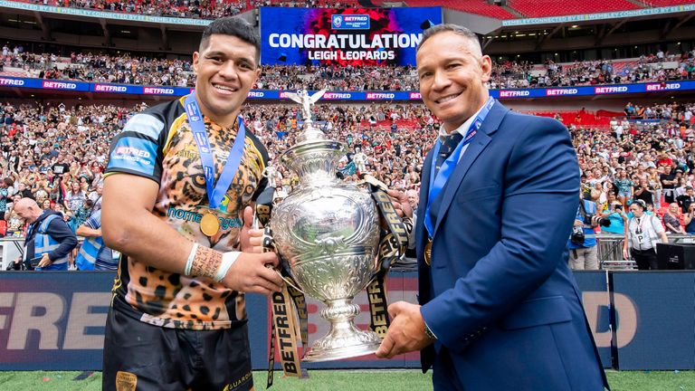 Picture by Allan McKenzie/SWpix.com - 12/08/2023 - Rugby League - Betfred Challenge Cup Final - Hull KR v Leigh Leopards - Wembley Stadium, London, England - Leigh's captain John Asiata & coach Adrian Lam with the Betfred Challenge Cup trophy in front of their fans after victory over Hull KR.