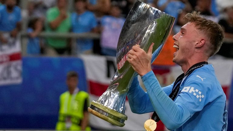 Cole Palmer of Manchester City celebrates with a trophy after winning the UEFA Super Cup final between Manchester City and Sevilla at the Georgios Karaiskakis Stadium in the port of Piraeus, near Athens, Greece, Wednesday August 16, 2023. (AP Photo/Thanasis Stavrakis)