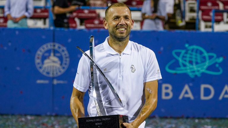 Dan Evans, of Britain, holds the trophy after defeating Tallon Griekspoor, of the Netherlands, in the men's singles final of the DC Open tennis tournament Sunday, Aug. 6, 2023, in Washington. (AP Photo/Alex Brandon)