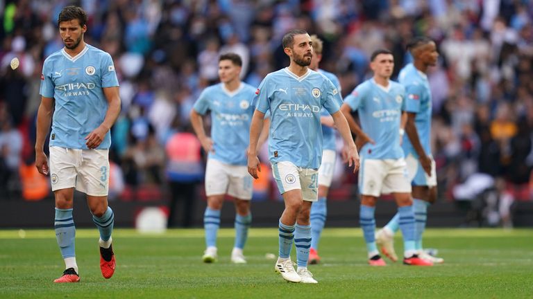 Dejected Manchester City players leave the pitch after losing the Community Shield to Arsenal on penalties