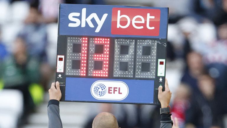 The fourth official holds up a board displaying 13 minutes of added on time are to be played during the Sky Bet Championship match at the Stadium of Light, Sunderland