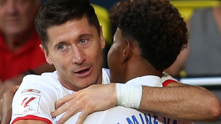 Barcelona&#39;s Robert Lewandowski, left, celebrates with Lamine Yamal after scoring his side&#39;s fourth goal during a Spanish La Liga soccer match between Villarreal and Barcelona at the Ceramica stadium in Villarreal, Spain, Sunday, Aug. 27, 2023. (AP Photo/Alberto Saiz)