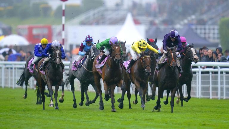 Magical Sunset (purple and white) wins the Oak Tree Stakes at Goodwood under Kevin Stott