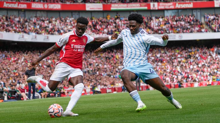 Bukayo Saka and Ola Aina in action at the Emirates Stadium