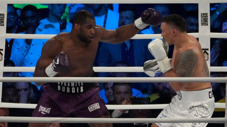 Britain's Daniel Dubois, left, and Ukraine's Oleksandr Usyk during their world heavyweight title fight at Tarczynski Arena in Wroclaw, Poland, Saturday, Aug. 26, 2023. Oleksandr Usyk defends his WBC, IBF and WBA heavyweight titles for the first time in a year when he faces hard-hitting British challenger Daniel Dubois in a clash of styles. (AP Photo/Czarek Sokolowski)