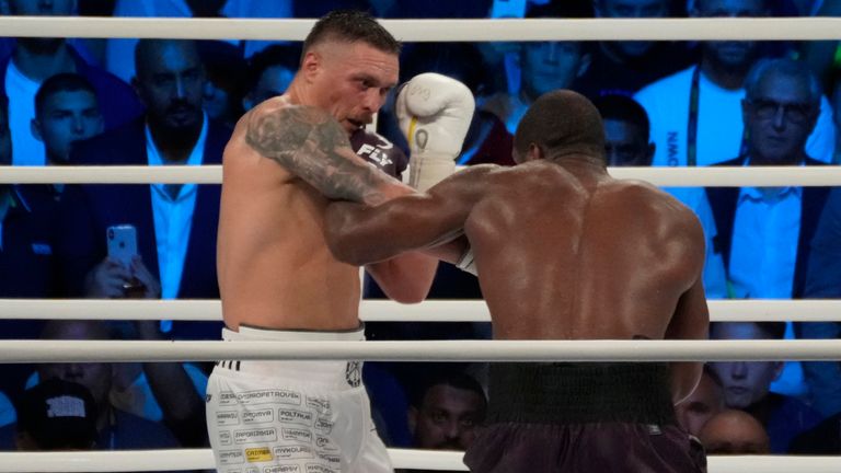 Ukraine's Oleksandr Usyk lands a blow on Britain's Daniel Dubois during their world heavyweight title fight at Tarczynski Arena in Wroclaw, Poland, Sunday, Aug. 27, 2023. Oleksandr Usyk defends his WBC, IBF and WBA heavyweight titles for the first time in a year when he faces hard-hitting British challenger Daniel Dubois in a clash of styles. (AP Photo/Czarek Sokolowski)
