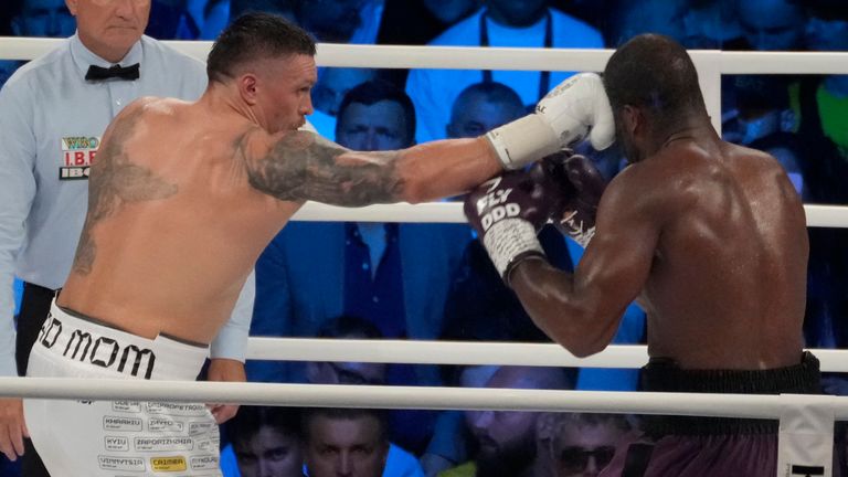 Ukraine's Oleksandr Usyk, left, lands a blow on Britain's Daniel Dubois during their world heavyweight title fight at Tarczynski Arena in Wroclaw, Poland, Sunday, Aug. 27, 2023. Oleksandr Usyk defends his WBC, IBF and WBA heavyweight titles for the first time in a year when he faces hard-hitting British challenger Daniel Dubois in a clash of styles. (AP Photo/Czarek Sokolowski)