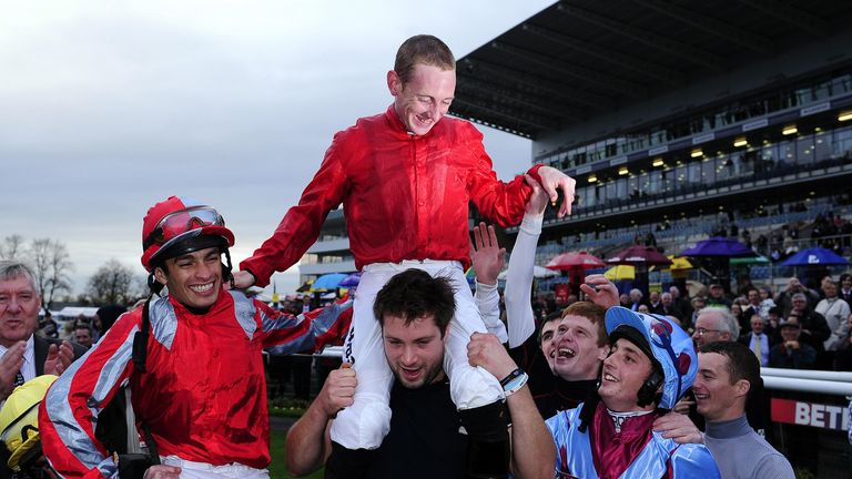 Hanagan is lifted up by his weighing room colleagues after winning his second champion jockeys&#39; title