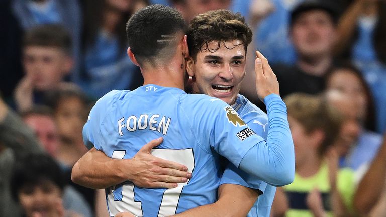 Julian Alvarez celebrates with Phil Foden after opening the scoring for Manchester City against Newcastle