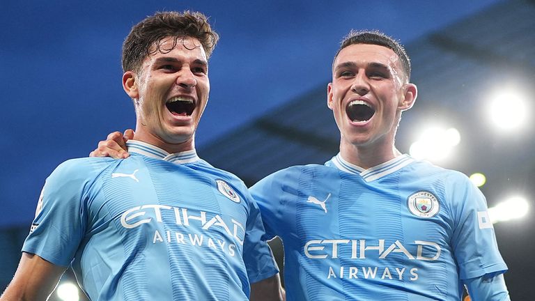 Julian Alvarez celebrates with team-mate Phil Foden after scoring Man City's opening goal against Newcastle