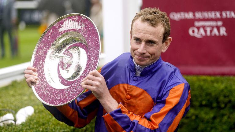 Ryan Moore holds aloft the Sussex Stakes trophy