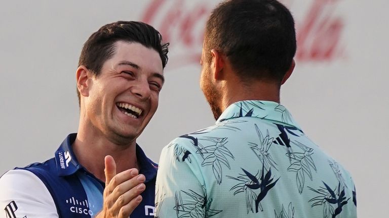 Viktor Hovland, of Norway, speaks to Xander Schauffele after Hovland won the Tour Championship golf tournament, Sunday, Aug. 27, 2023, in Atlanta. (AP Photo/John Bazemore)