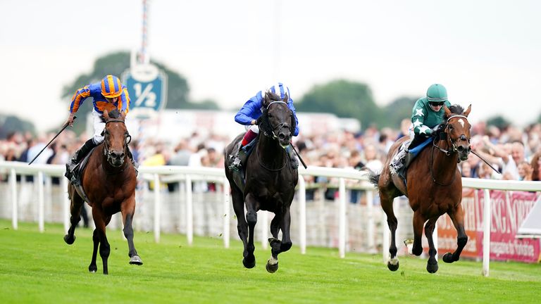 Mostahdaf holds off Nashwa (right) and Paddington (left) to win the Juddmonte International