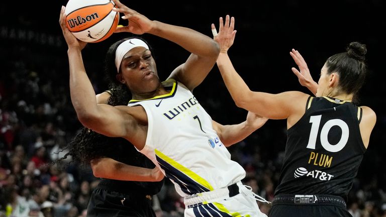Dallas Wings&#39; Teaira McCowan passes around Las Vegas Aces guard Kelsey Plum (10) during the second half in Game 2 of a WNBA basketball semifinal series Tuesday, Sept. 26, 2023, in Las Vegas. 