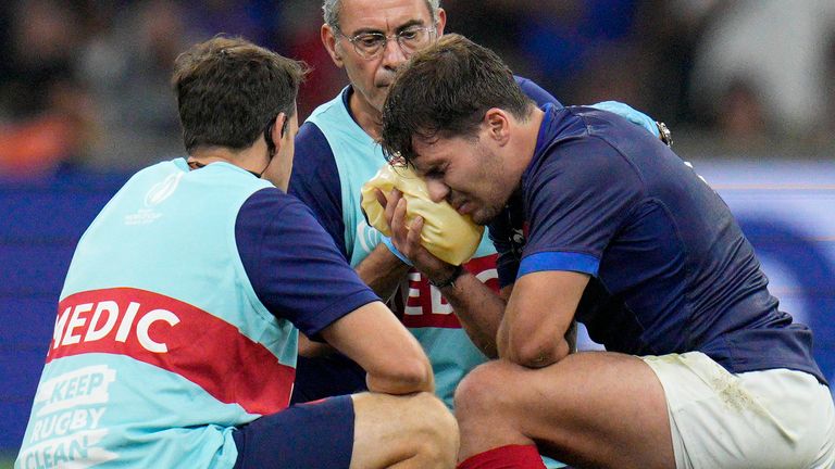 France's Antoine Dupont receives treatment after taking a knock to the jaw