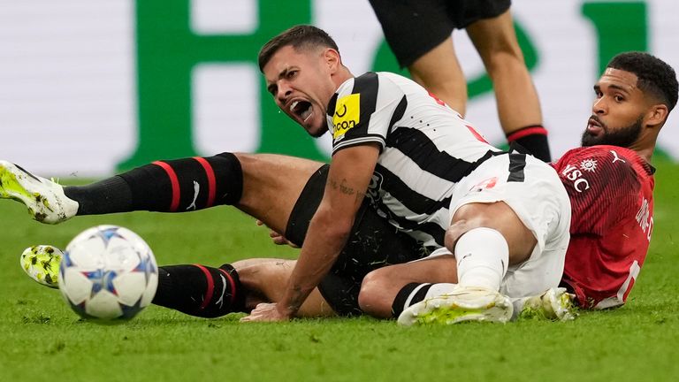 Newcastle's Bruno Guimaraes, left, challenges for the ball with AC Milan's Ruben Loftus-Cheek, during the Champions League group F soccer match between AC Milan and Newcastle at the San Siro stadium in Milan, Italy, Tuesday, Sept. 19, 2023. (AP Photo/Antonio Calanni)