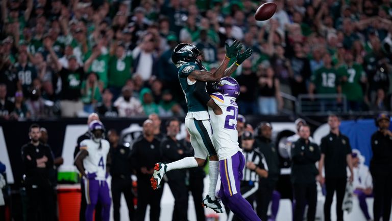 Philadelphia Eagles wide receiver DeVonta Smith (6) reaches for the ball in front of Minnesota Vikings safety Theo Jackson (25) during the first half of an NFL football game Thursday, Sept. 14, 2023, in Philadelphia.