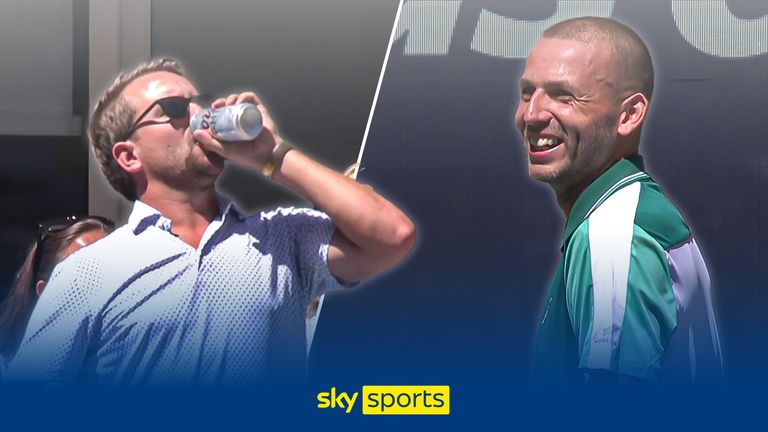 Daniel Evans laughs at a man drinking a beer