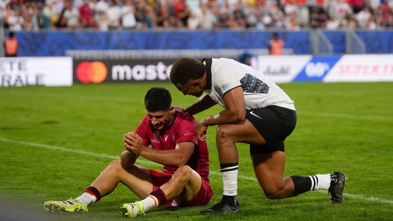 Fiji's Teti Tela, right, comforts Georgia's Luka Matkava at their defeat in the Rugby World Cup