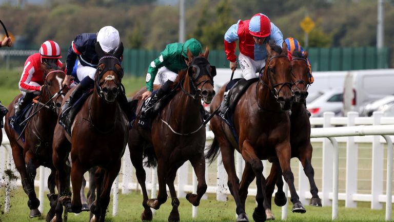 16/1 shot Moss Tucker (blue and red) wins the Group One Flying Five Stakes