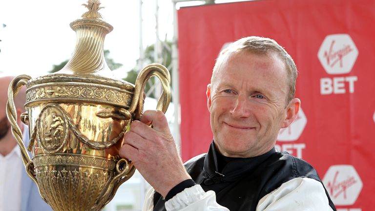 Joe Fanning lifts the Ayr Gold Cup after victory on Significantly