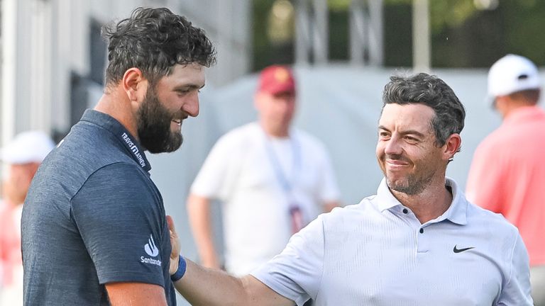 ATLANTA, GA - AUGUST 24: Jon Rahm (left) and Rory McIlroy (right) shake hands after round one of the 2023 PGA Tour Championship on August 24, 2023 at East Lake Golf Club in Atlanta, Georgia. (Photo by John Adams/Icon Sportswire) (Icon Sportswire via AP Images)