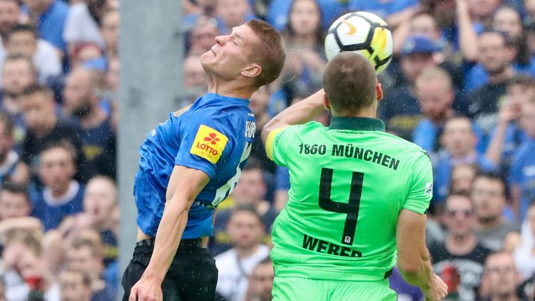     Kevin Behrens of 1.FC Saarbrücken challenges Felix Weber of TSV 1860 Muenchen during the third league first round match between 1.FC Saarbruecken and TSV 1860 Muenchen at Hermann-Neuberger-Stadion on May 24, 2018 in Voelklingen, Germany.