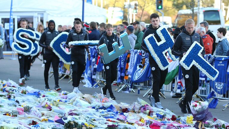Leicester City players lead by goalkeeper Kasper Schmeichel (right) carry wreaths following the accident