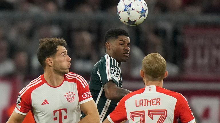 Manchester United's Marcus Rashford, centre, is challenged by Bayern's Leon Goretzka, left, and Konrad Laimer during the Champions League group A soccer match between Bayern Munich and Manchester United at the Allianz Arena stadium in Munich, Germany, Wednesday, Sept. 20, 2023. (AP Photo/Matthias Schrader)