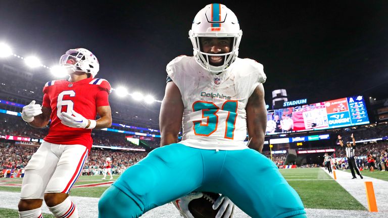 Miami Dolphins running back Raheem Mostert (31) celebrates after his touchdown against the New England Patriots during the fourth quarter of an NFL football game, Sunday, Sept. 17, 2023, in Foxborough, Mass. (AP Photo/Michael Dwyer)