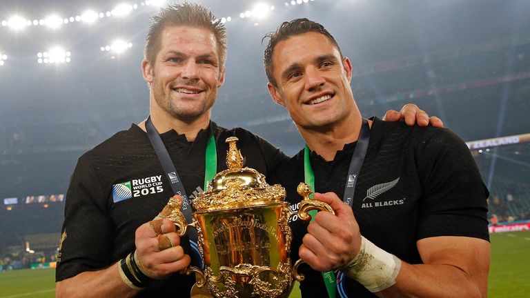 New Zealand's captain Richie McCaw, left, and Dan Carter hold the trophy aloft after the Rugby World Cup final between New Zealand and Australia at Twickenham Stadium in London,  Saturday, Oct. 31, 2015.  The All Blacks won 34-17. (AP Photo/Christophe Ena)