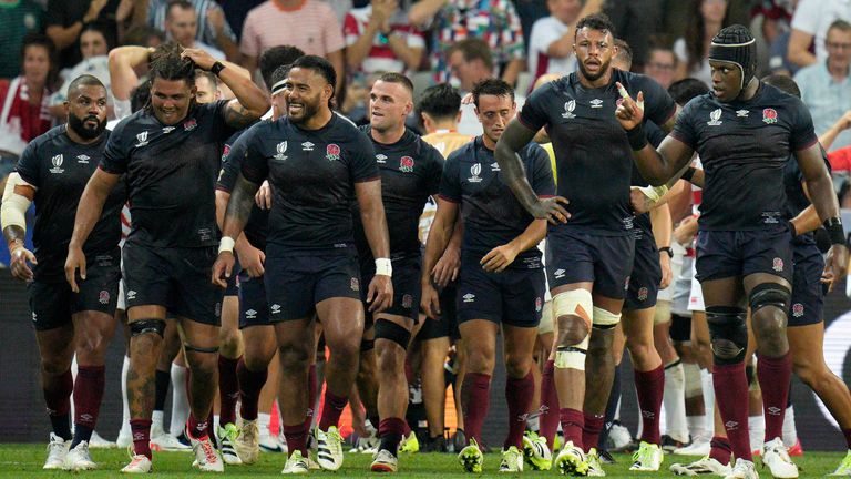 England players walk back after England's Lewis Ludlam scored a try during the Rugby World Cup Pool D match between England and Japan in the Stade de Nice, in Nice, France Sunday, Sept. 17, 2023. (AP Photo/Daniel Cole)
