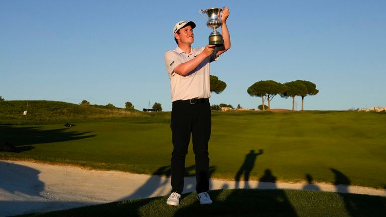 Bob MacIntyre of Scotland holds the trophy after winning the Italian Open golf tournament in Guidonia Montecelio, near Rome, Italy, Sunday, Sept. 18, 2022. The Italian Open took place on the Marco Simone course that will host the 2023 Ryder Cup. (AP Photo/Alessandra Tarantino)