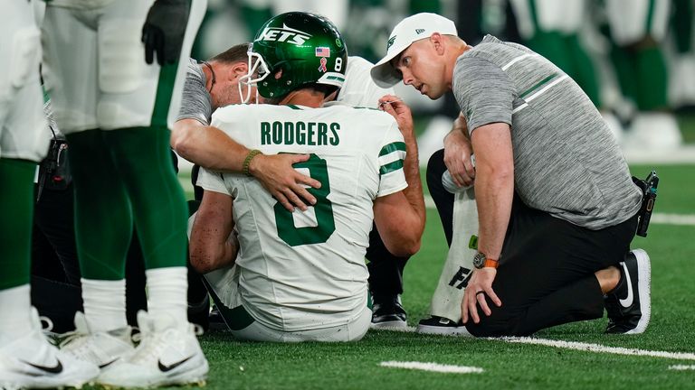 New York Jets quarterback Aaron Rodgers (8) is tended to on the field during the first quarter of an NFL football game against the Buffalo Bills, Monday, Sept. 11, 2023, in East Rutherford, N.J.