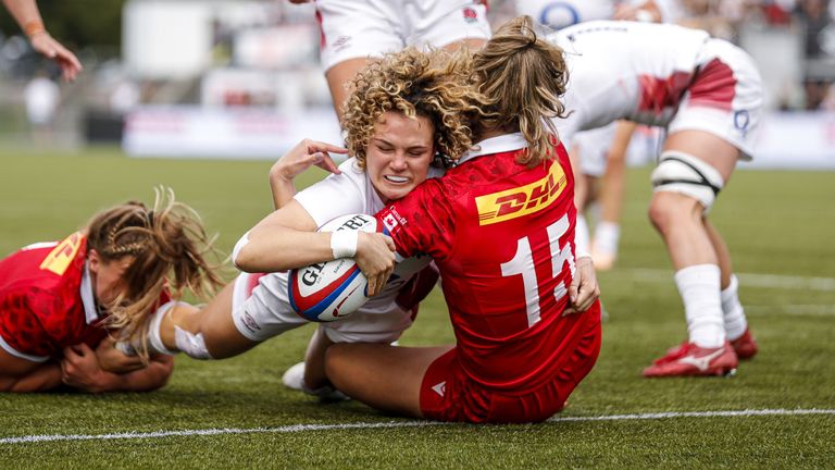 England's Ellie Kildunne scores a try despite Canada's Sophie de Goede (left) and Madison Grant (right) during the second test match at StoneX Stadium